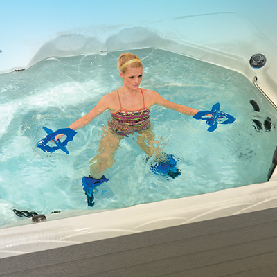 Woman doing resistance training in H2X Swim Spa